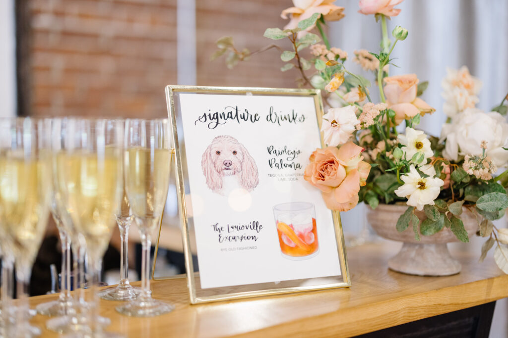 signature drink menu with champagne flute glasses and flowers 