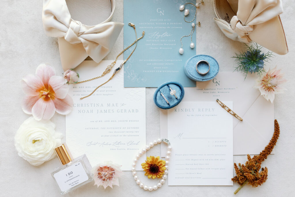 dusty blue and white stationery with ivory heels with bows and floral accessories