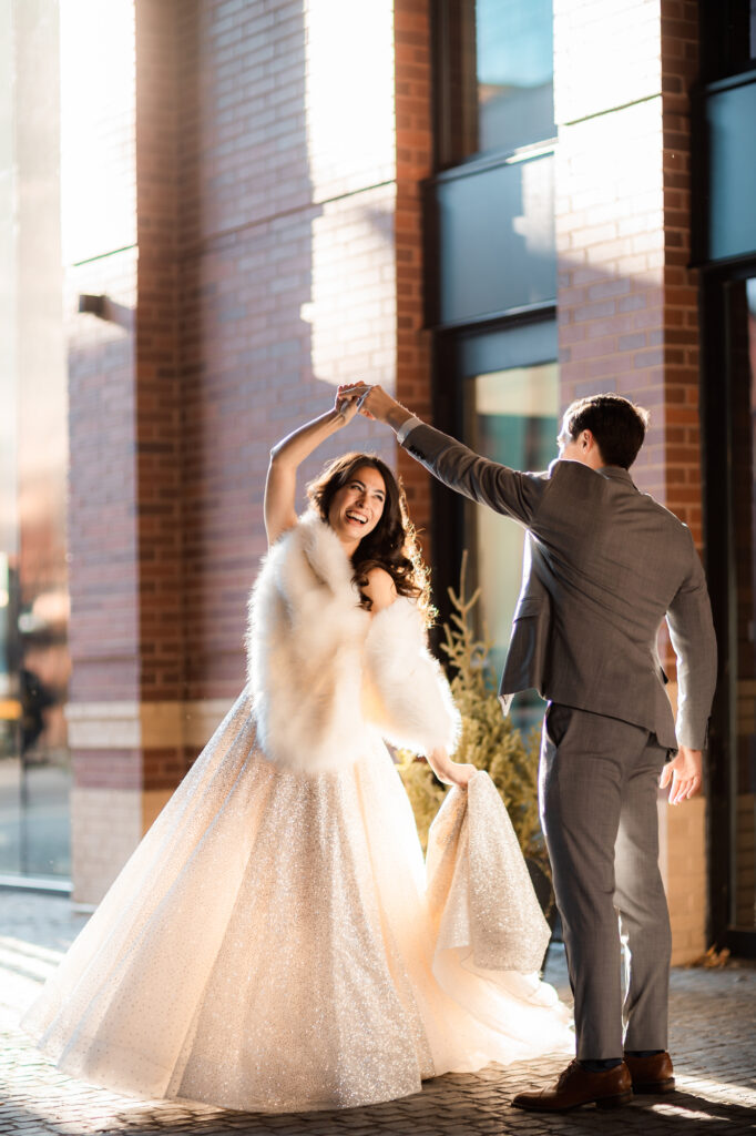 bride in a ballgown dancing with her groom outside Aria