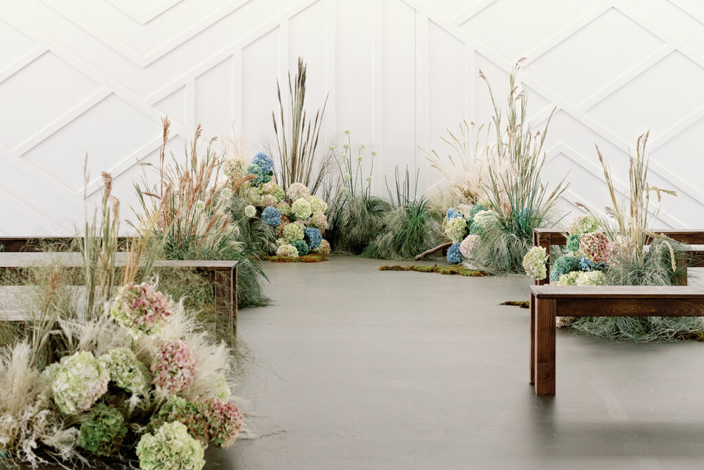 array of wild grasses and beautiful natural florals in wedding ceremony space