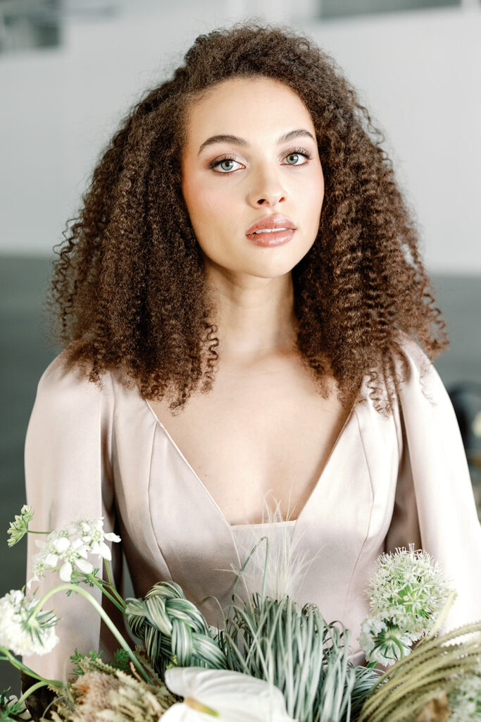 modern bride pictured with natural curly hair and organic makeup with light blush tones